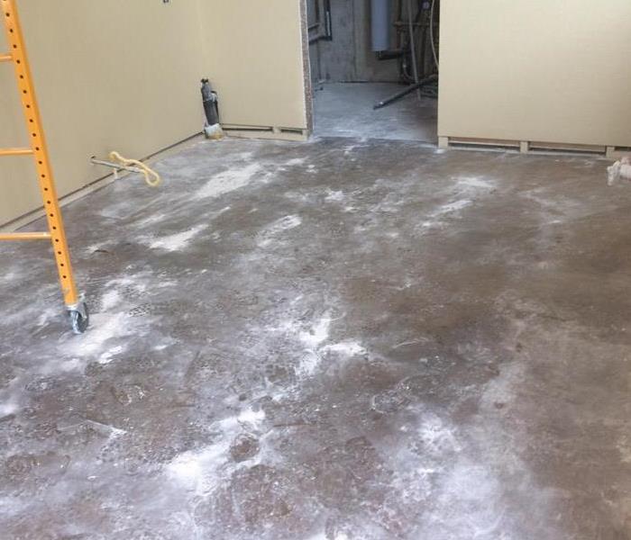 An empty room full of dust after the drywall was sanded. 