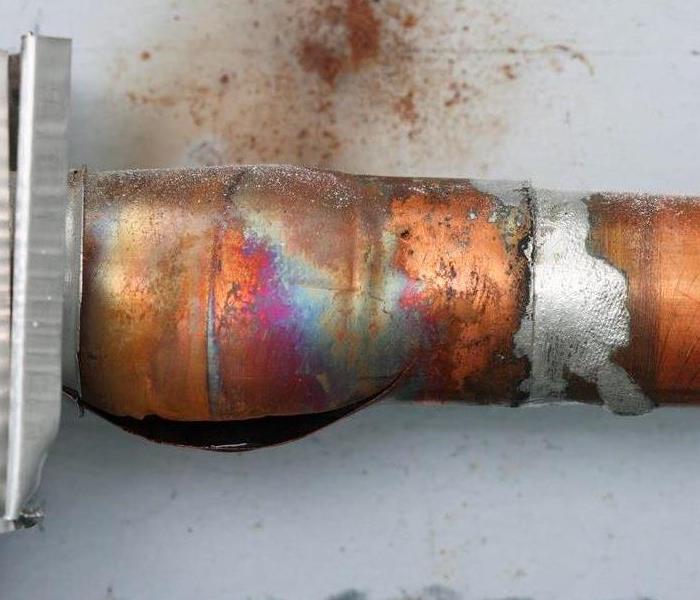 Copper line that has a hole in it from it freezing.