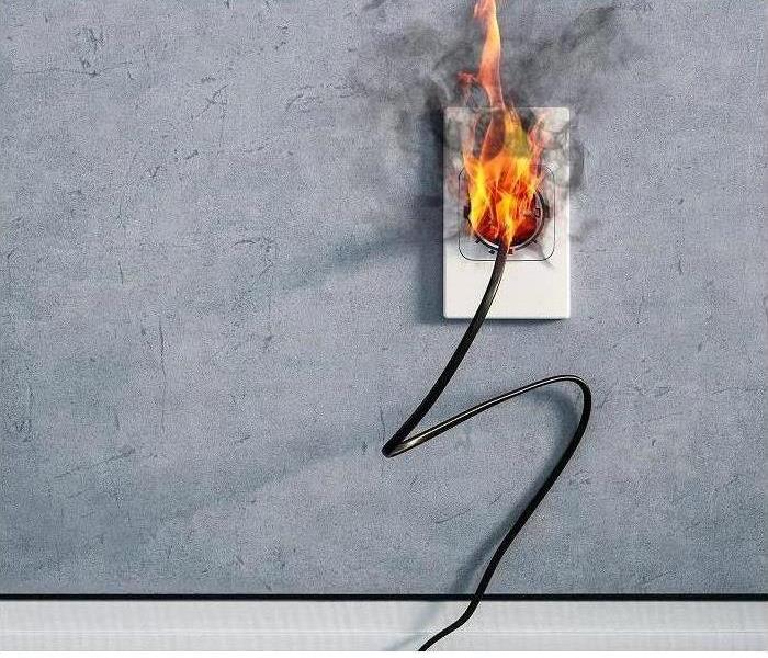 power outlet plug with fire coming out of the plug.